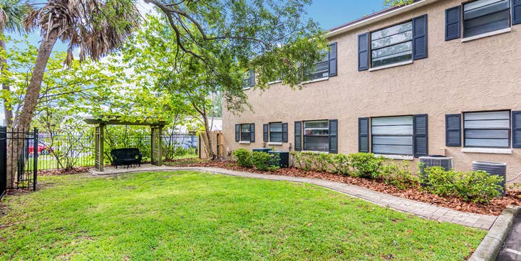 A yard with a bench swing