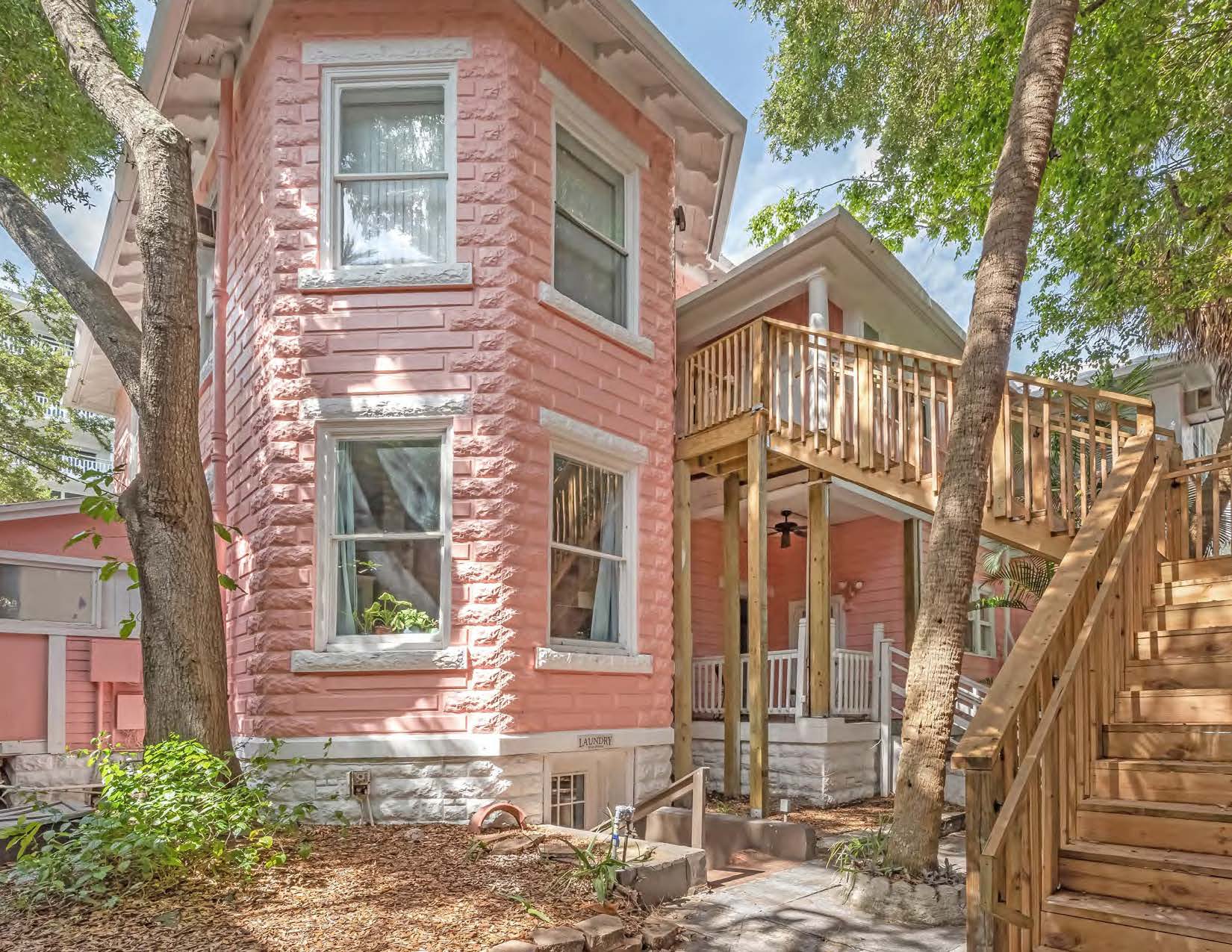 stairs leading up to the second floor of a pink building